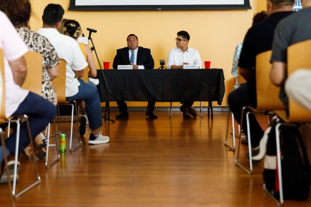 San Diego, California - Antonio Martinez, longtime San Ysidro school board trustee, and Gerardo Ramirez, chief of staff of termed-out incumbent Vivian Moreno, speak during a candidate forum for the District 8 seat on the San Diego City Council at the Otay Mesa-Nestor Library in Otay Mesa West on Wednesday, Sept. 9, 2026. (Kristian Carreon / The San Diego Union-Tribune)
