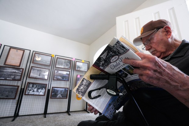 At the Chula Vista Museum and History Center in Chula Vista, Earl Jantz, 84, glances over a book by Steven Schoenherr, "Chula Vista Centennial: A Century of People and Progress, 1911-2011." (Nelvin C. Cepeda / The San Diego Union-Tribune)