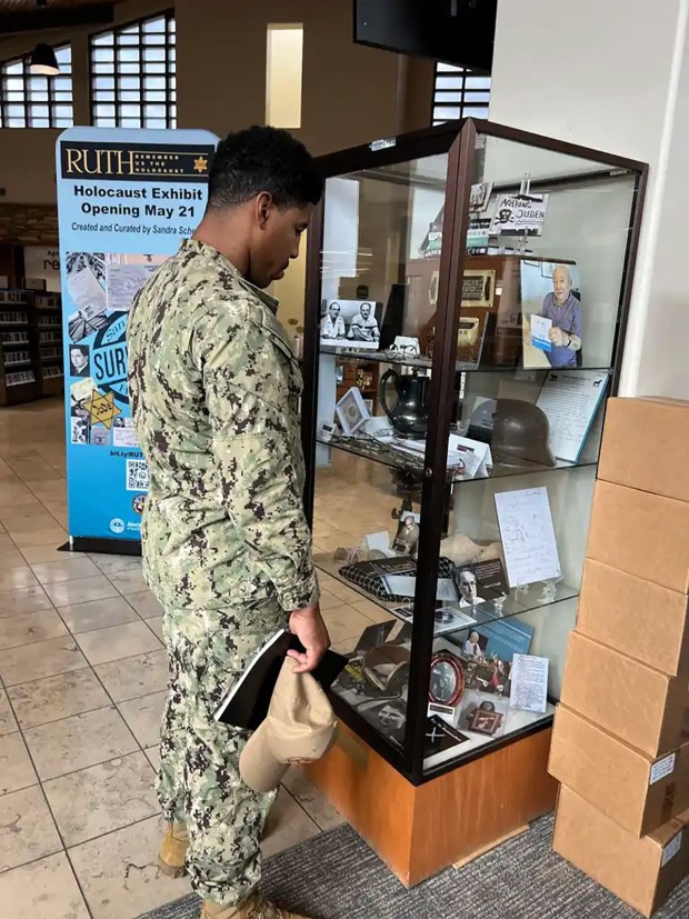 A serviceman examines artifacts in "RUTH: Remember Us the Holocaust" at a library in La Jolla last spring. The exhibit is now open at the San Diego Central Library. (RUTH)