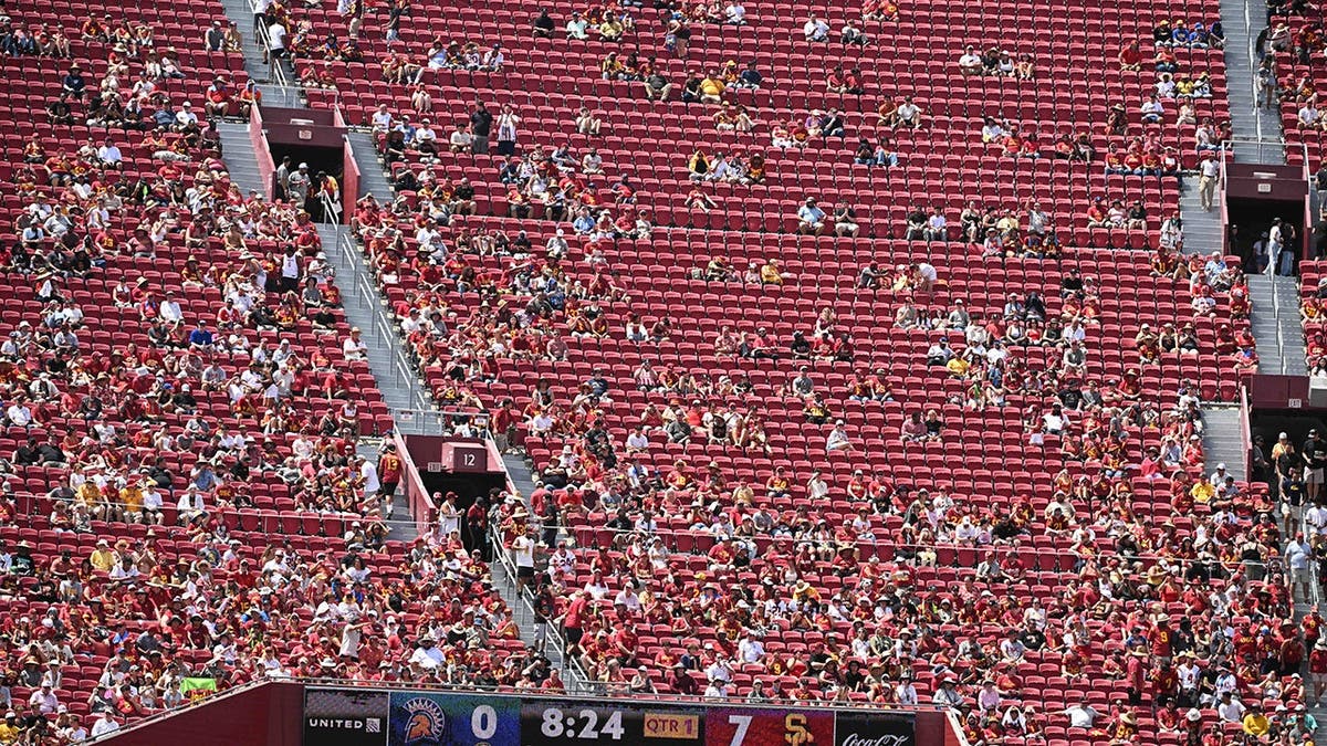 Football fans look on during an NCAA game at the Los Angeles Memorial Coliseum.