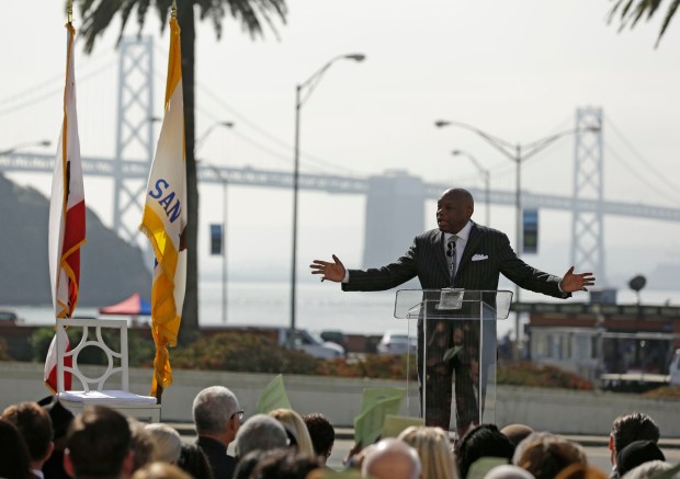 Willie Brown, the former San Francisco mayor and California State Assembly speaker, gestures while speaking during the dedication of the Willie L. Brown Jr. Bridge at Treasure Island on Tuesday, Feb. 11, 2014, in San Francisco. The western span of the bridge in the background was renamed for Brown. (AP Photo/Eric Risberg)
