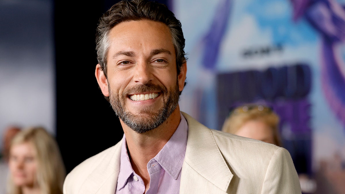 Zachary Levi poses for photos at a press event.