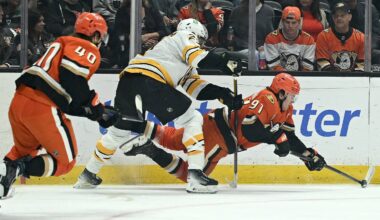 Oct 16, 2026; Anaheim, California, USA;  Anaheim Ducks center Leo Carlsson (91) and Boston Bruins defenseman Hampus Lindholm (27) battle for the puck during the first period at Honda Center.  Mandatory Credit: Griffin Hooper-Imagn Images
