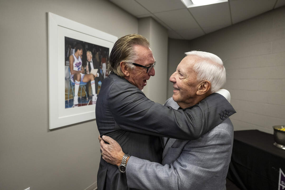 Gary “G-Man” Gerould, the legendary radio play-by-play voice of the Sacramento Kings since 1985, is embraced by Los Angeles Lakers television play-by-play announcer Bill Macdonald after being recognized for his work with the permanent naming of the Golden 1 Center press workspace as the Gary 'G-Man' Gerould Media Center on Monday, Oct. 5, 2026.