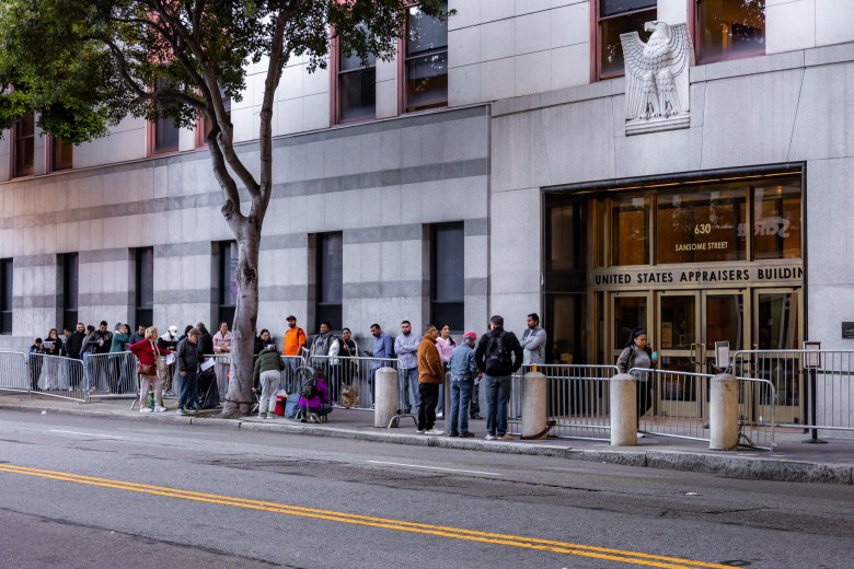 San Francisco educators standing in a long line on the sidewalk in front of the United States Appraisers Building at 630 Sansome Street.