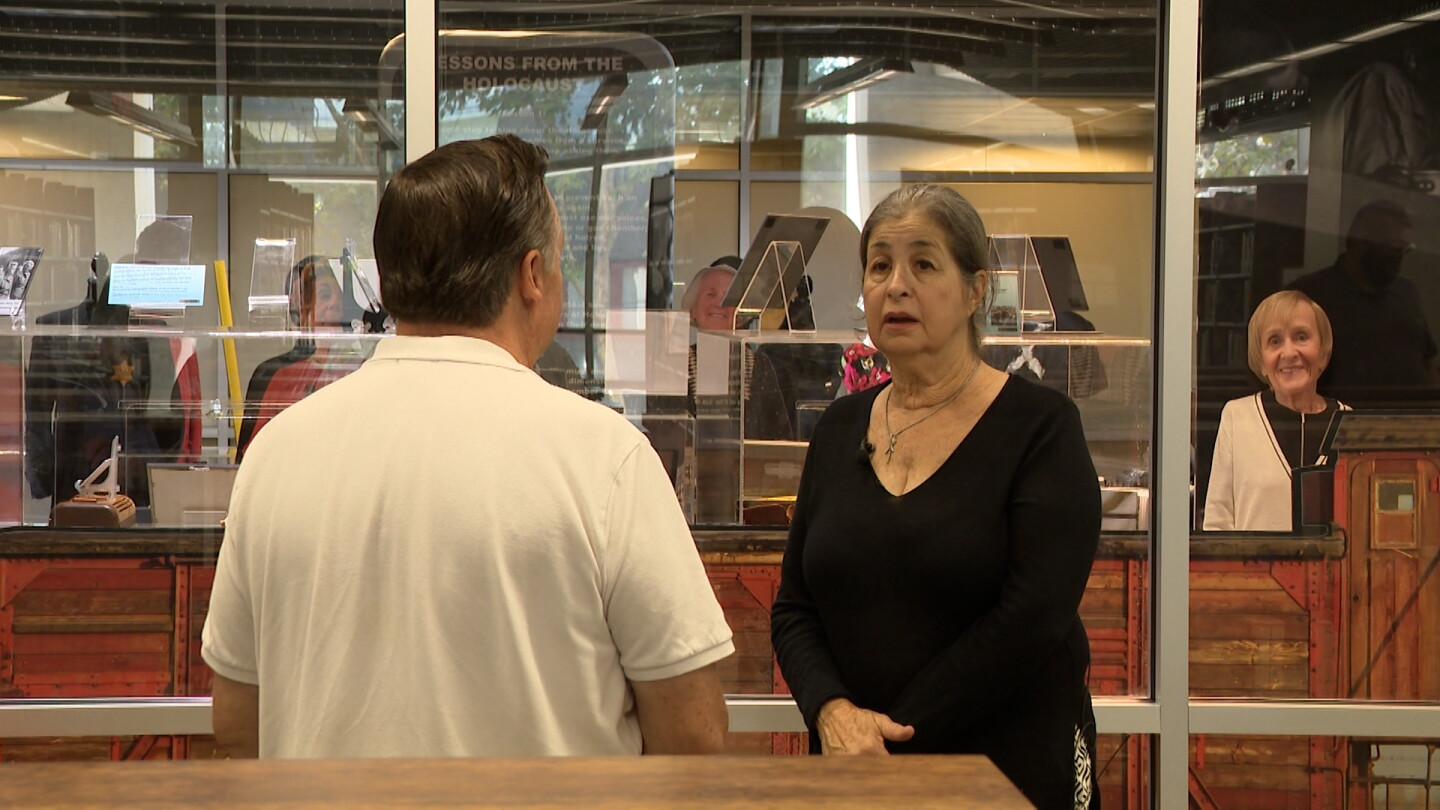 RUTH founder and president Sandra Scheller is shown being interviewed by KPBS reporter John Carroll at the Central Library on Sept. 8, 2026.