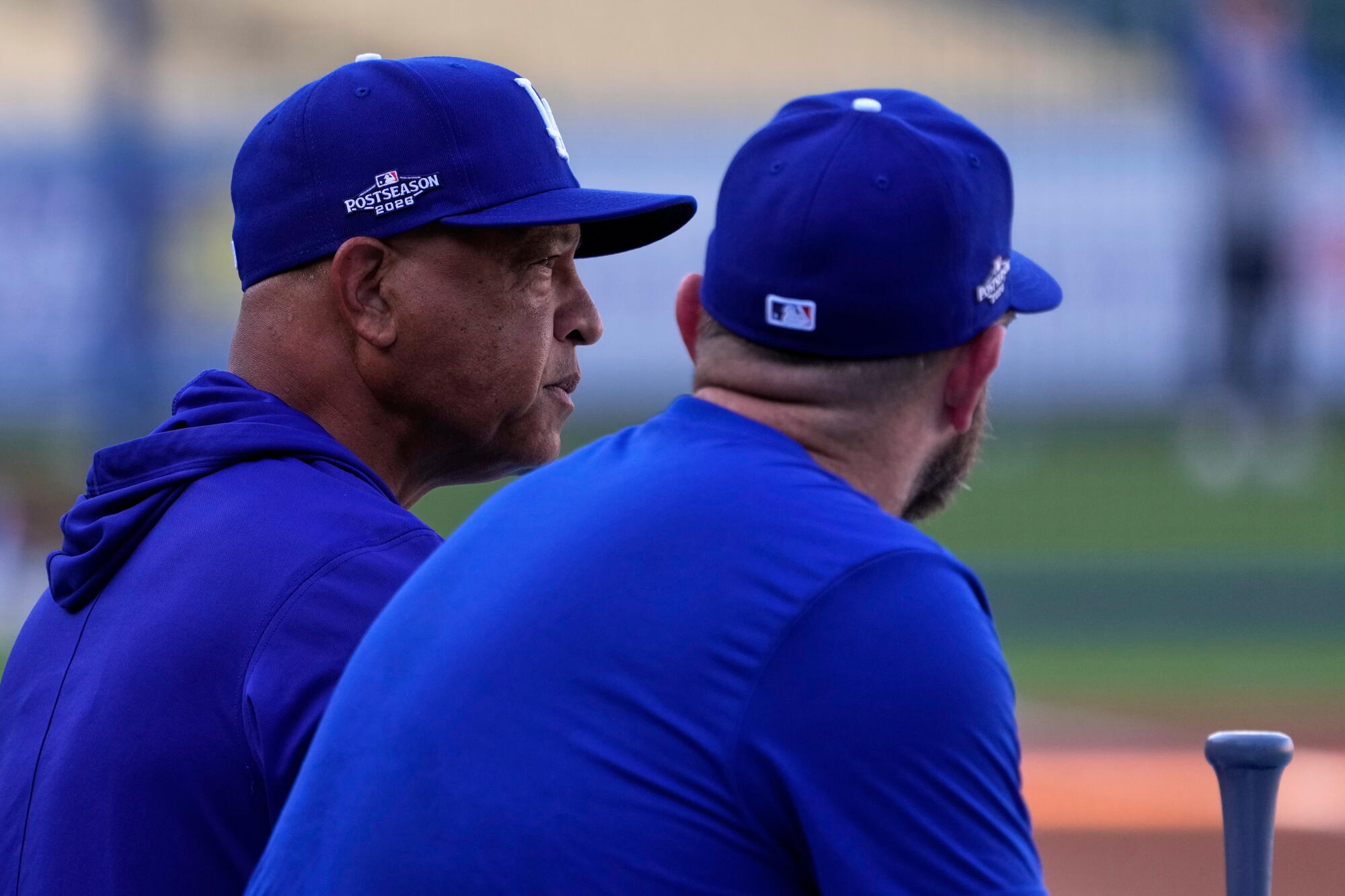 Dodgers manager Dave Roberts, left, talks with third baseman Max Muncy during practice Thursday.