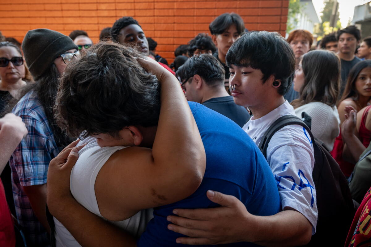 Students embrace at a vigil