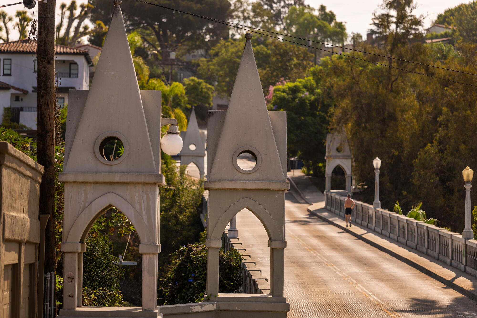 A jogger crosses the Shakespeare Bridge.