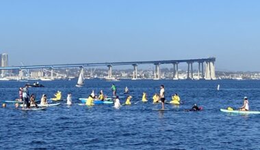 SD Climate week paddle out in Glorietta Bay with bridge in background.