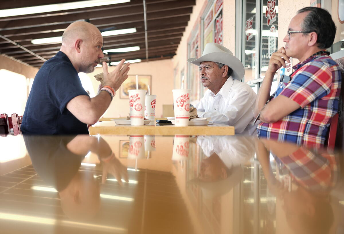 Gustavo Arellano and his father Lorenzo Arellano chat with gubernatorial candidate Steve Hilton.