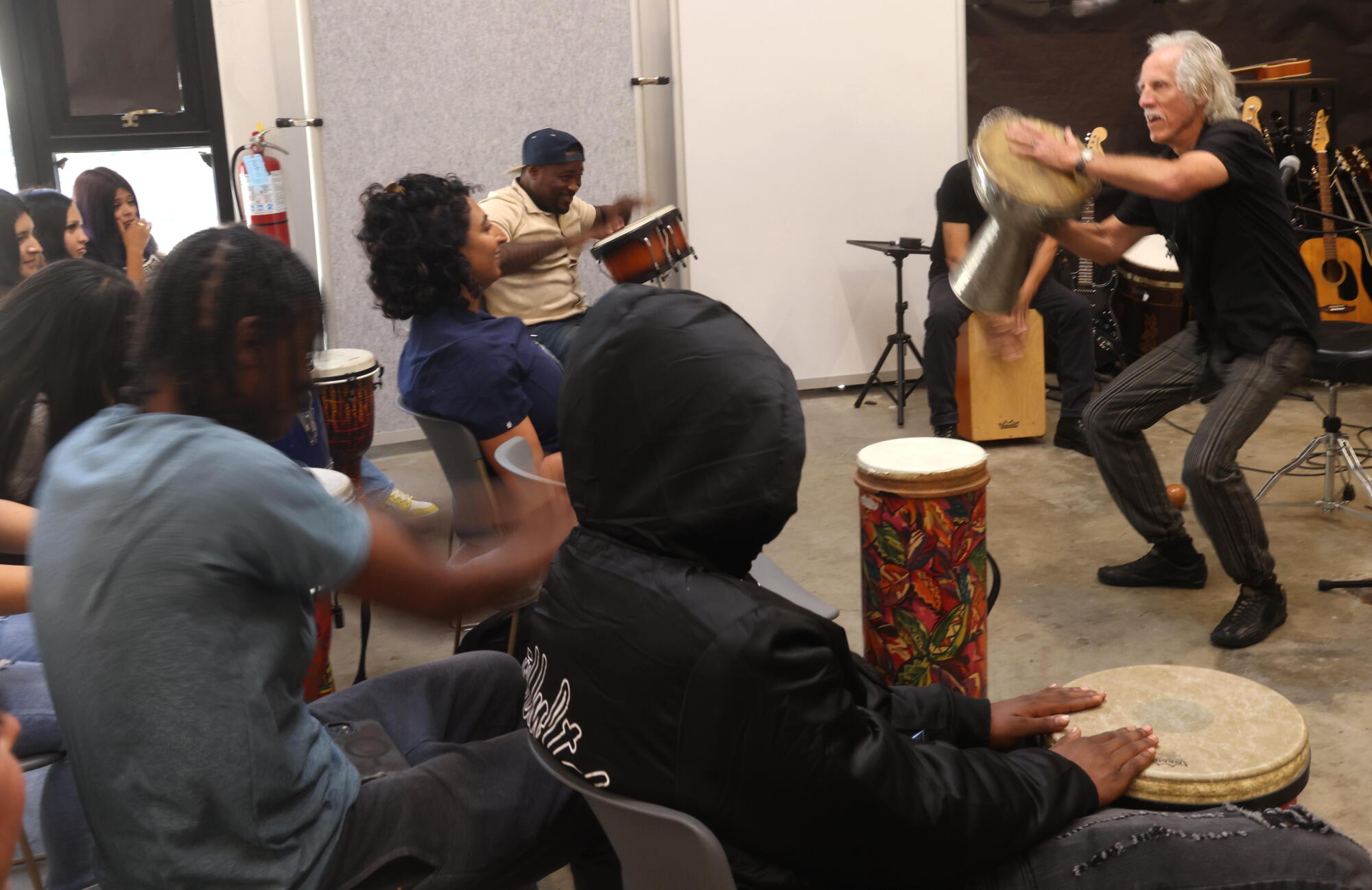 Doors drummer John Densmore, right, leads a jam session at Homeboy Art Academy in downtown Los Angeles.