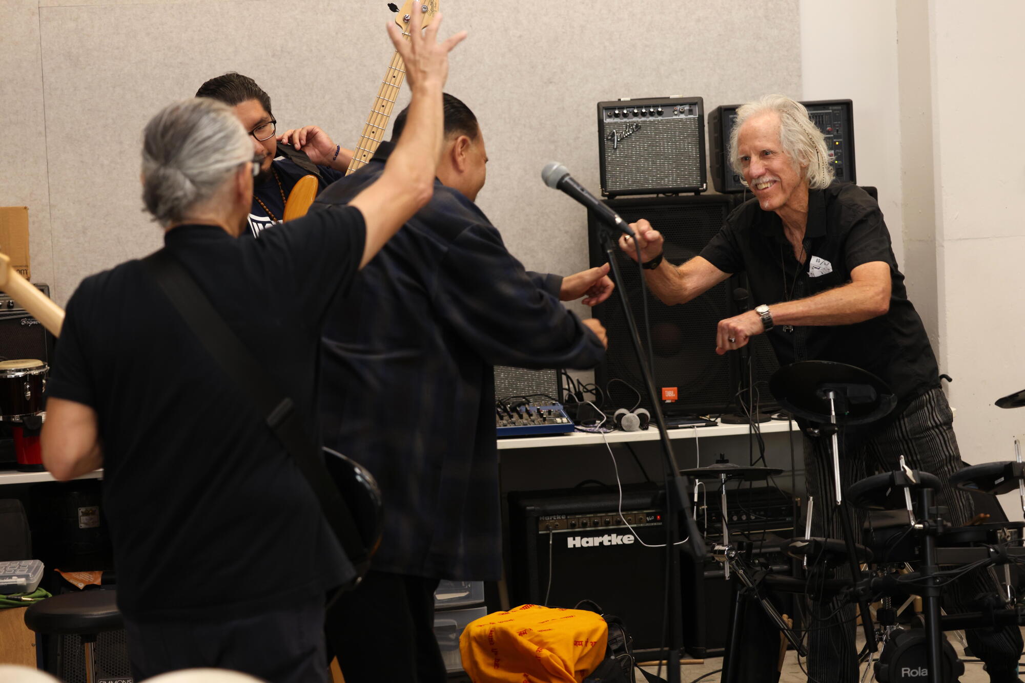 John Densmore, right, congratulates musicians after they performed.