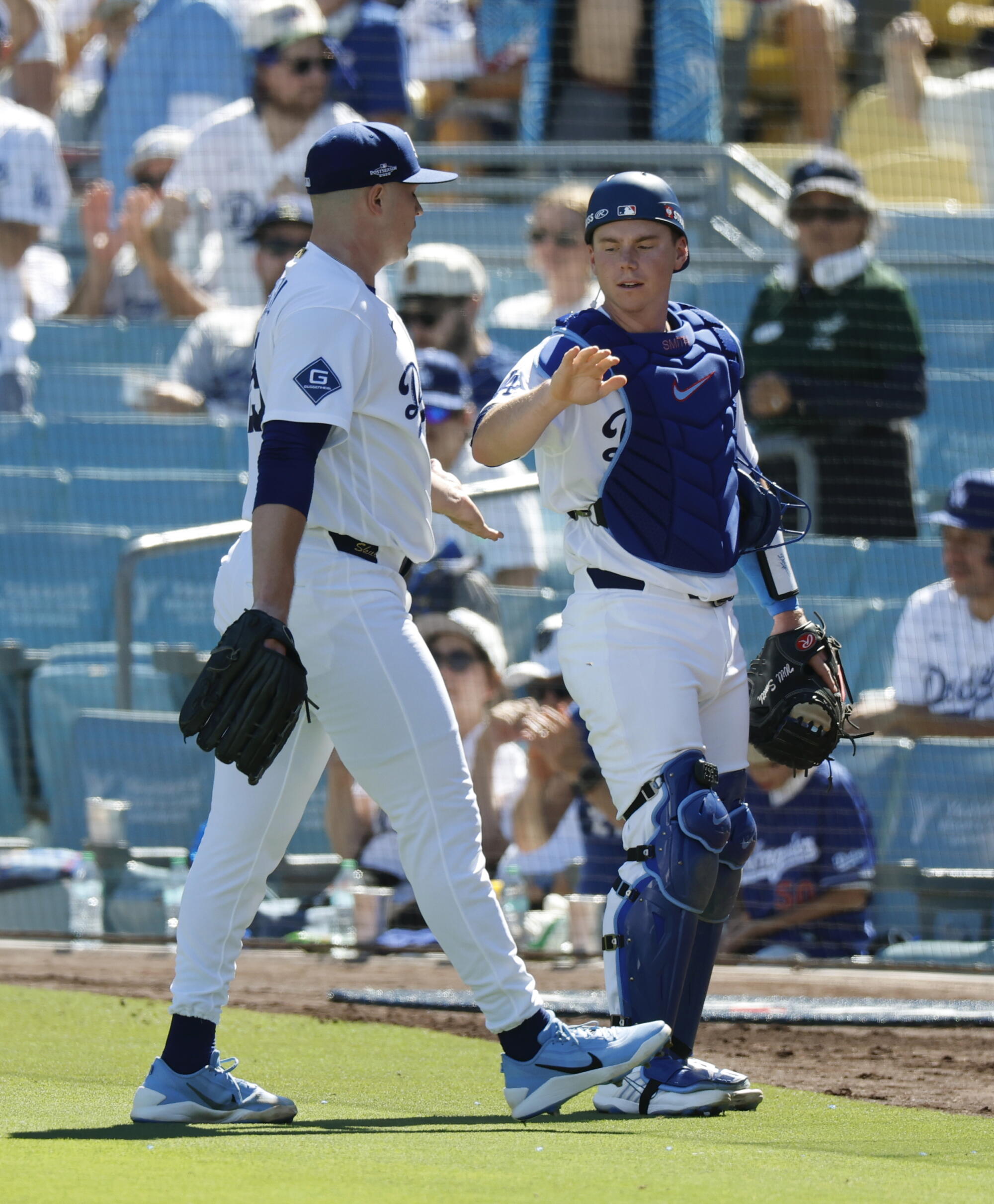 Dodger pitcher Tarik Skubal is congratulated by Will Smith after making quick work of the Braves in the second inning.