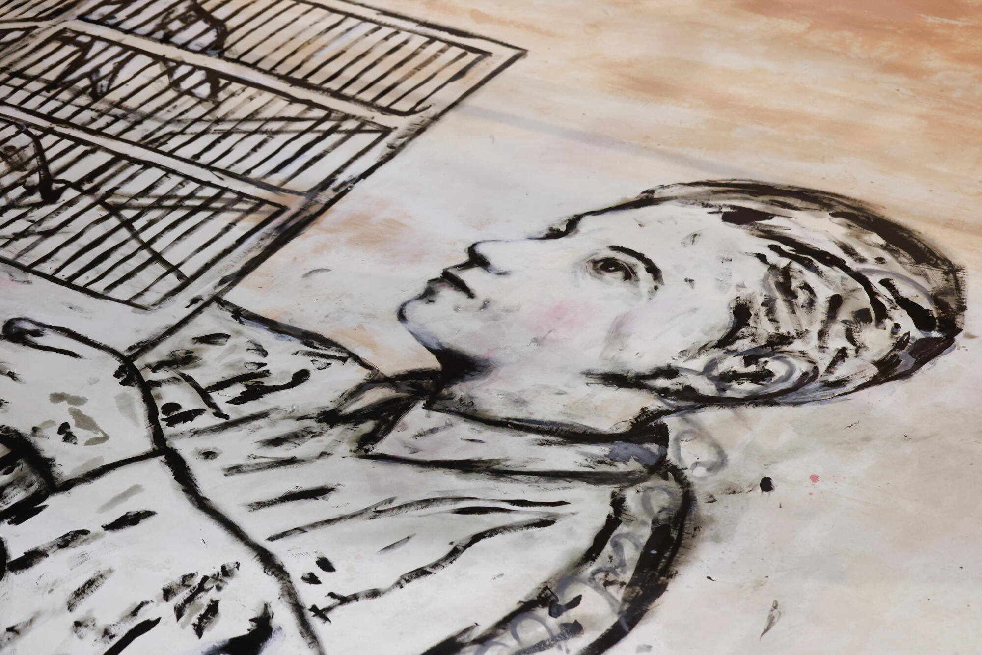 A detail of a little boy drawn on a canvas.