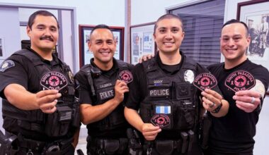 officers holding pink patches