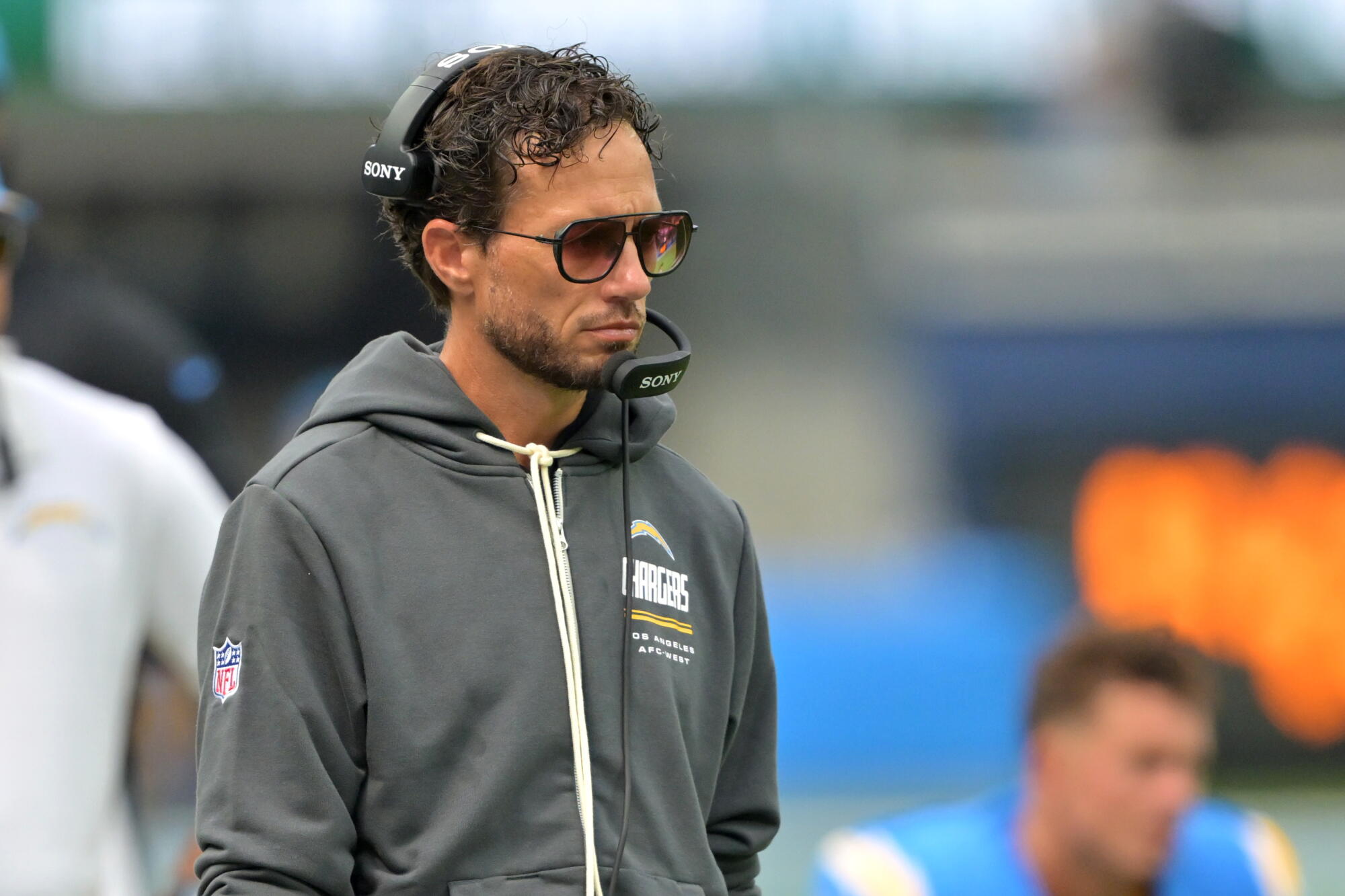 Chargers offensive coordinator Mike McDaniel watches from the sideline during a loss to the Las Vegas Raiders.