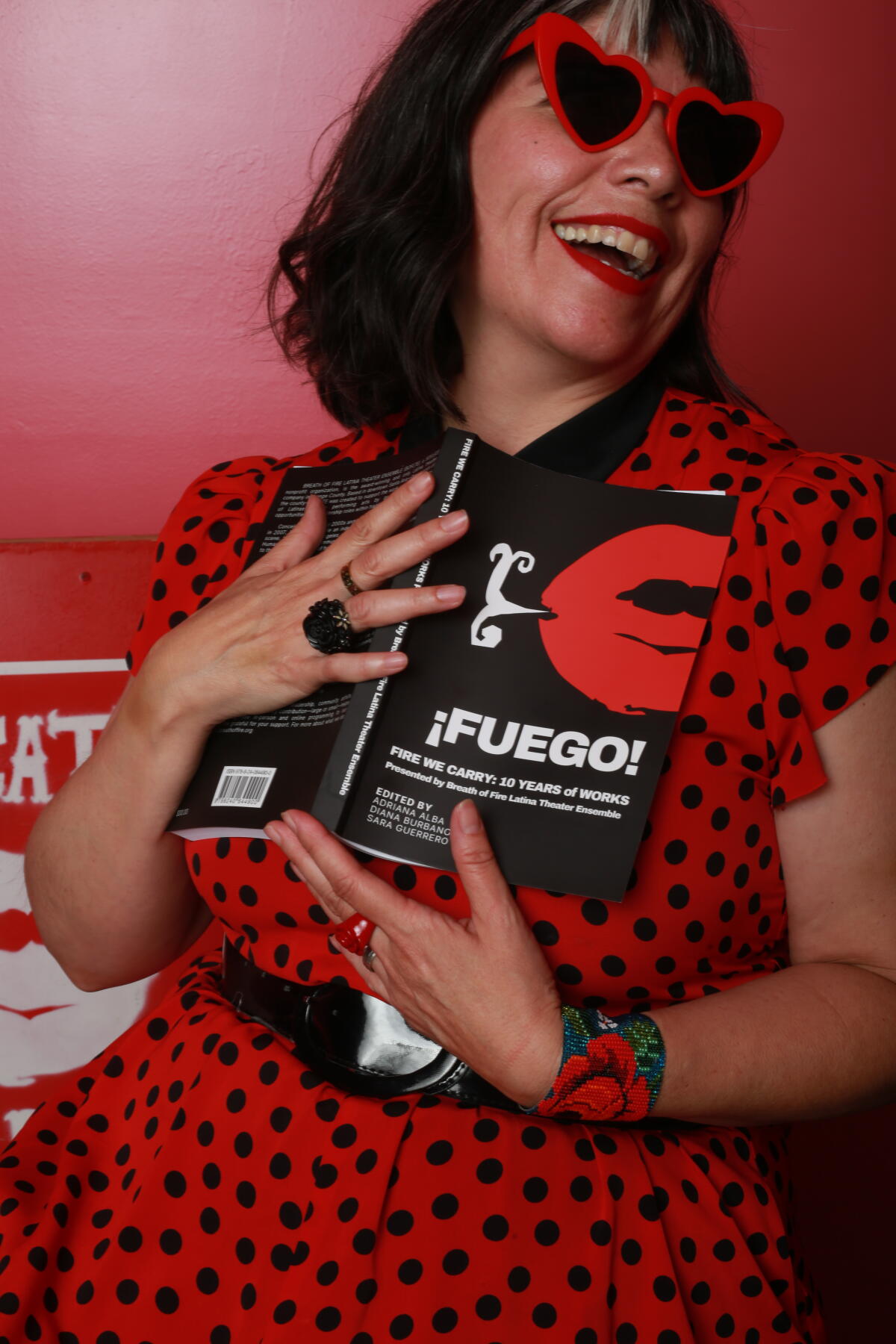 Sara Guerrero holds a copy of Breath of Fire Latina Theater Ensemble anthology, “‘¡Fuego!"
