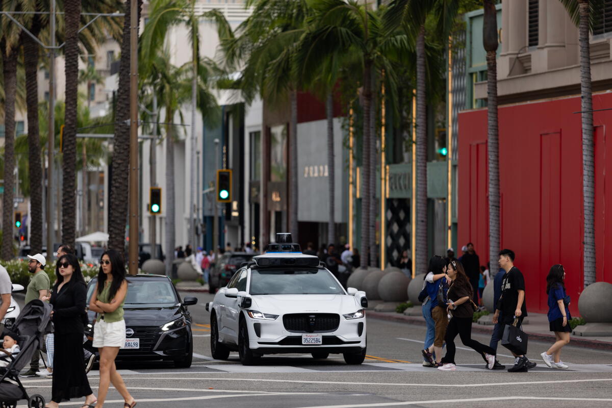 A Waymo car drives down Rodeo Drive in Beverly Hills. 