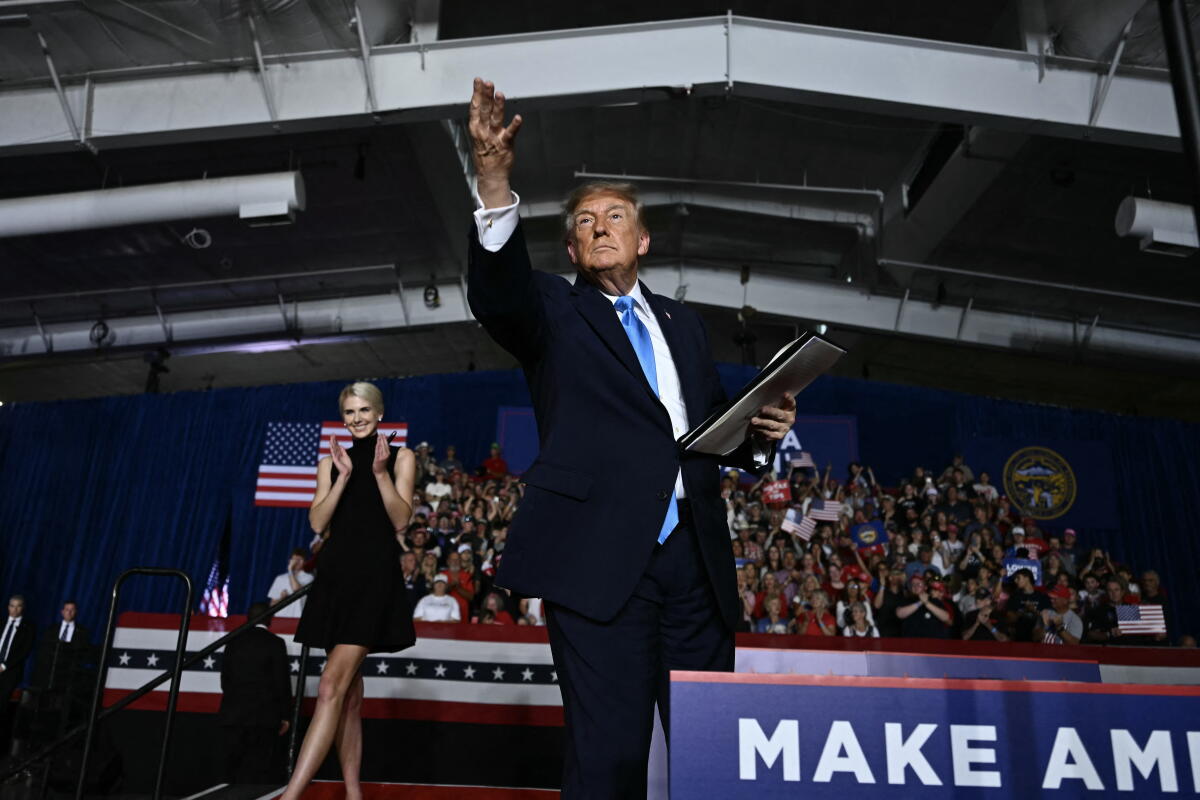 President Trump throws a pen into the crowd during a campaign rally