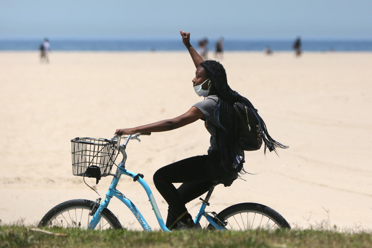 A bicyclist riding on Ocean Front Walk in Venice Beach