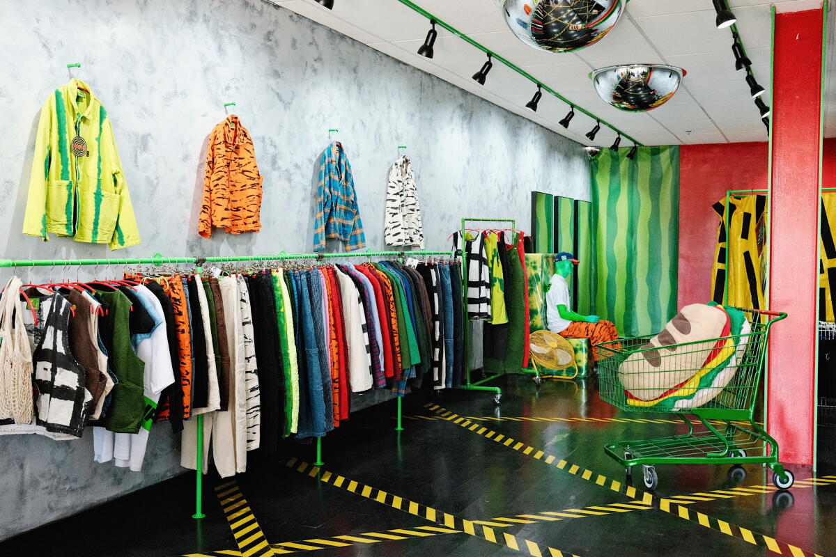 Racks of colorful, food-inspired work jackets, forager vests and chef pants at the Meals Clothing storefront.
