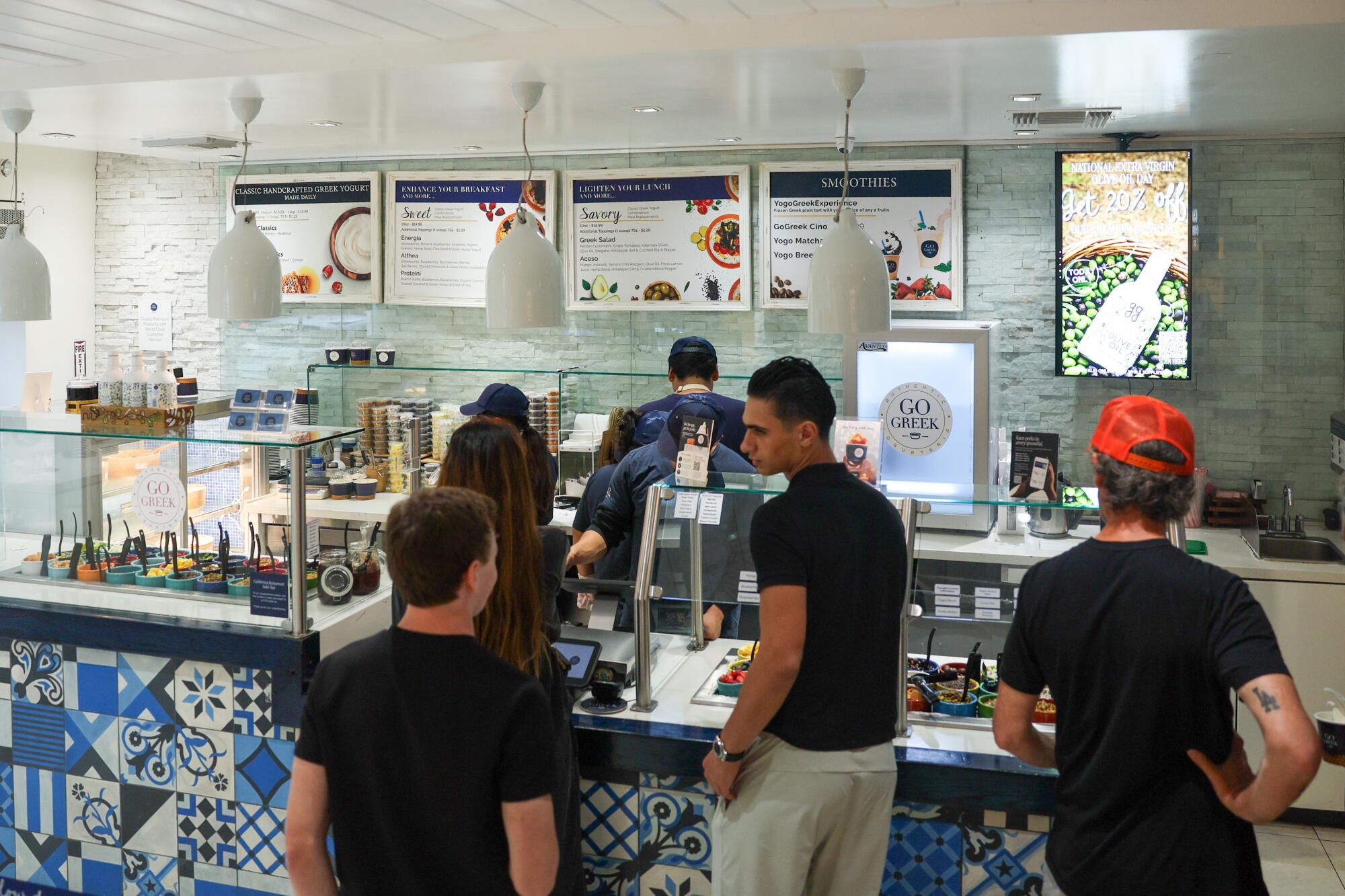 People wait in line to order custom yogurt bowls at Go Greek in Beverly Hills.