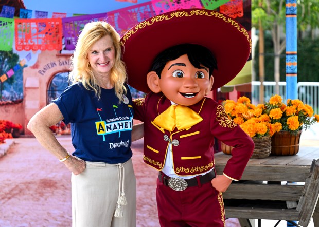 Jill Estorino, president of Disneyland Resort, hangs out with Miguel, from Coco, during Disney's "Happiest Day in Anaheim" at Center Greens Park in Anaheim on Thursday, August 27, 2026. Disney celebrated 70 years by inviting more than 3,000 Anaheim residents to, "Happiest Day in Anaheim Main Street on Your Street - with Disney characters, performances, games and treats. (Photo by Jeff Gritchen, Orange County Register/SCNG)