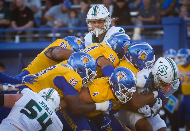 San Jose State Spartans' Naseri Danielson (3), San Jose State Spartans' Dylan Lee (4), San Jose State Spartans' Malakai Hoeft (24), San Jose State Spartans' Dejon Roney (48) and San Jose State Spartans' Nate Lewis (99) tackle Cal Poly Mustangs' Misa Paiau (0) during the first quarter at CEFCU Stadium in San Jose, Calif., on Saturday, Sept. 12, 2026. (Shae Hammond/Bay Area News Group)