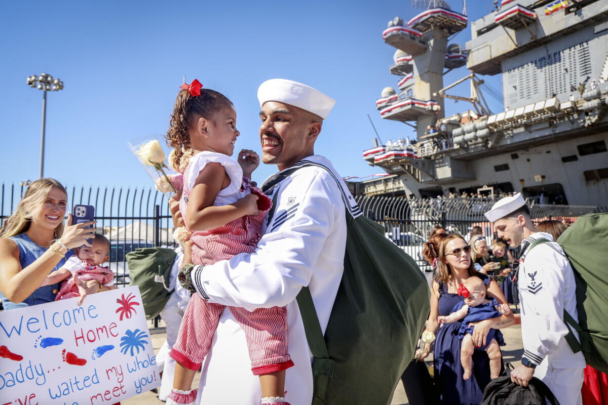 Mitchell Brown hugs loved ones after the USS Abraham Lincoln arrived at North Island Naval Air Station.