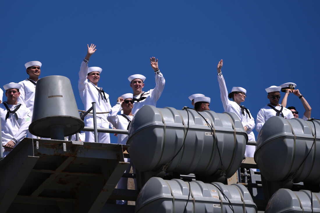 Sailors wave aboard the USS Abraham Lincoln aircraft carrier as it returns to Naval Air Station North Island after deployment Thursday, Oct. 8, 2026, in Coronado, Calif.
