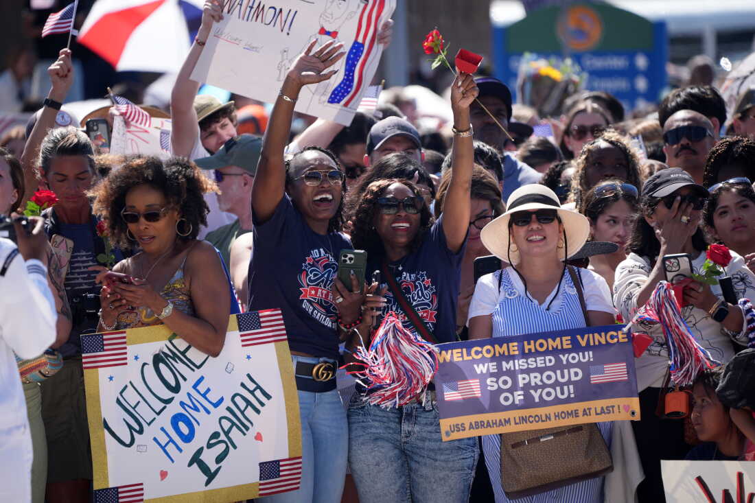 Family and friends cheer as the USS Abraham Lincoln aircraft carrier returns to Naval Air Station North Island after deployment Thursday, Oct. 8, 2026, in Coronado, Calif.