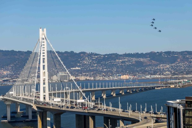 The U.S. Navy Blue Angels fly over the Bay Bridge and the San Francisco Bay during a practice flight for San Francisco Fleet Week, as seen from Treasure Island in San Francisco, Calif., on Thursday, Oct. 8, 2026. (Ray Chavez/Bay Area News Group)