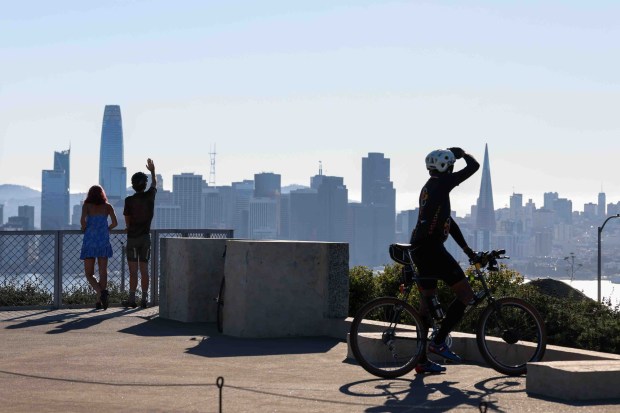 Spectators watch the U.S. Navy Blue Angels fly over the San Francisco Bay during a practice flight for San Francisco Fleet Week, as seen from Treasure Island in San Francisco, Calif., on Thursday, Oct. 8, 2026. (Ray Chavez/Bay Area News Group)