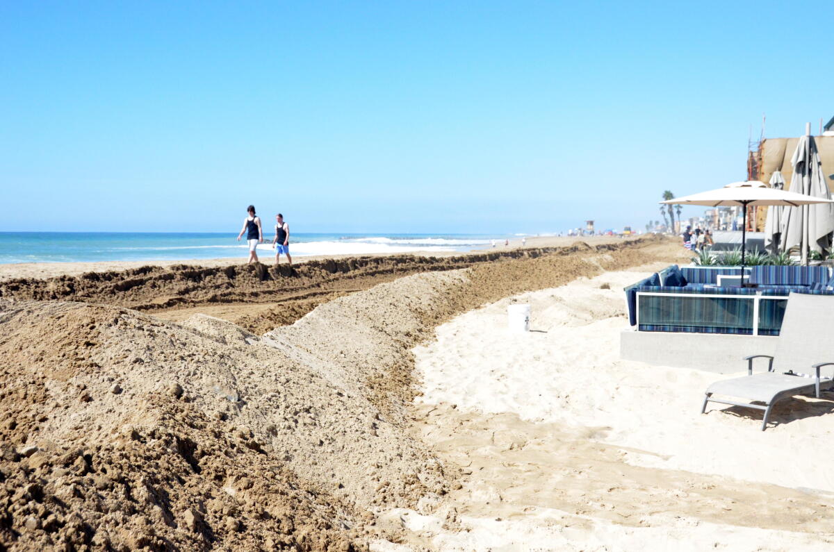 A sand berm protects oceanfront property along the Balboa Peninsula