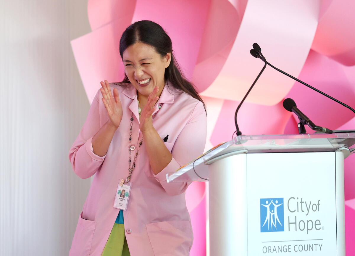 Dr. Jennifer Tseng, medical director of breast surgery at City of Hope Orange County, introduces a survivor on Wednesday.