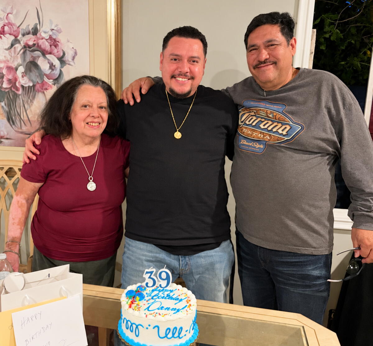 Family courtesy photograph of Daniel Magaña with parents.
