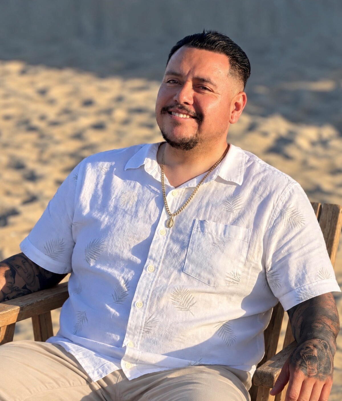Daniel Magaña sits on the beach.
