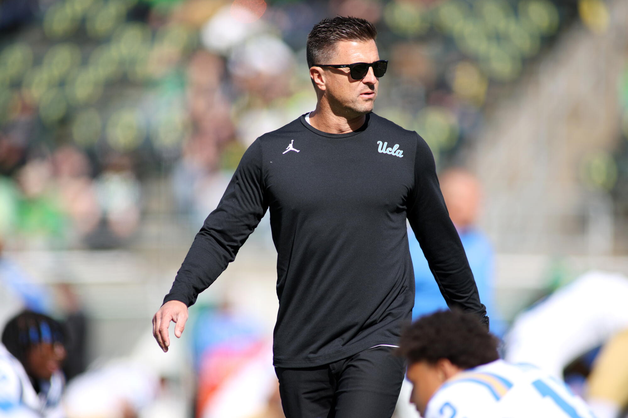 UCLA coach Bob Chesney watches his players warm up before playing Oregon Saturday in Eugene, Ore.