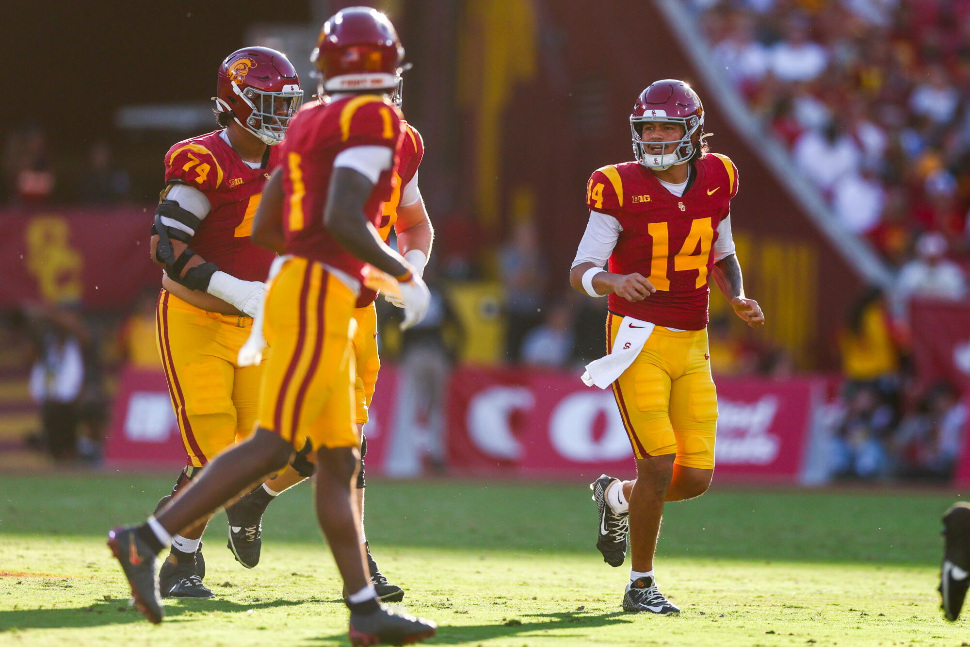 USC quarterback Jayden Maiava talks with teammates during a game against Washington at the Coliseum on Oct. 3.
