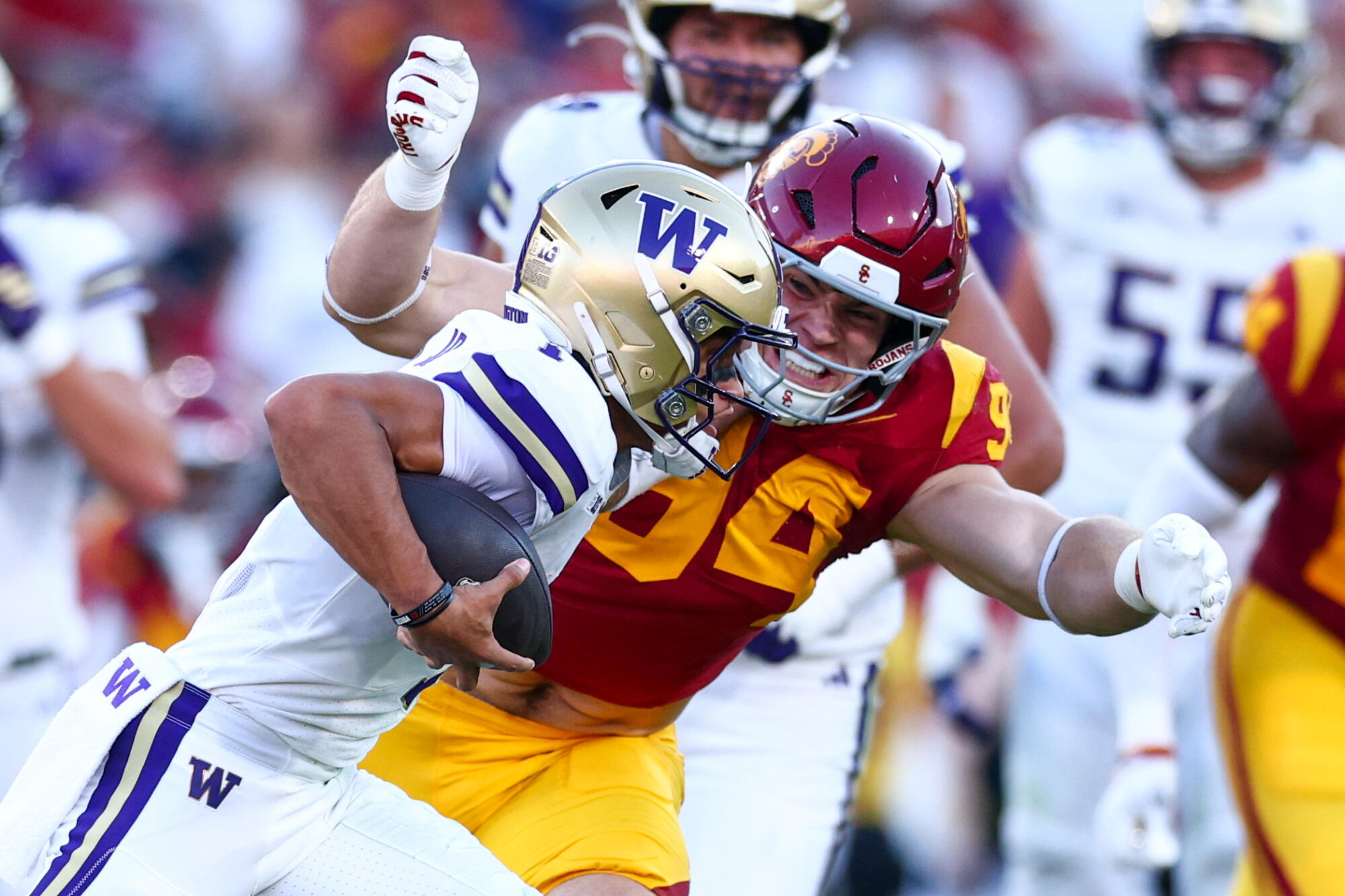 USC defensive end Luke Wafle closes in to tackle Washington quarterback Demond Williams Jr.