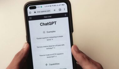 A person holds a cell phone open to a ChatGPT webpage, which is prompting the user to ask a series of questions.