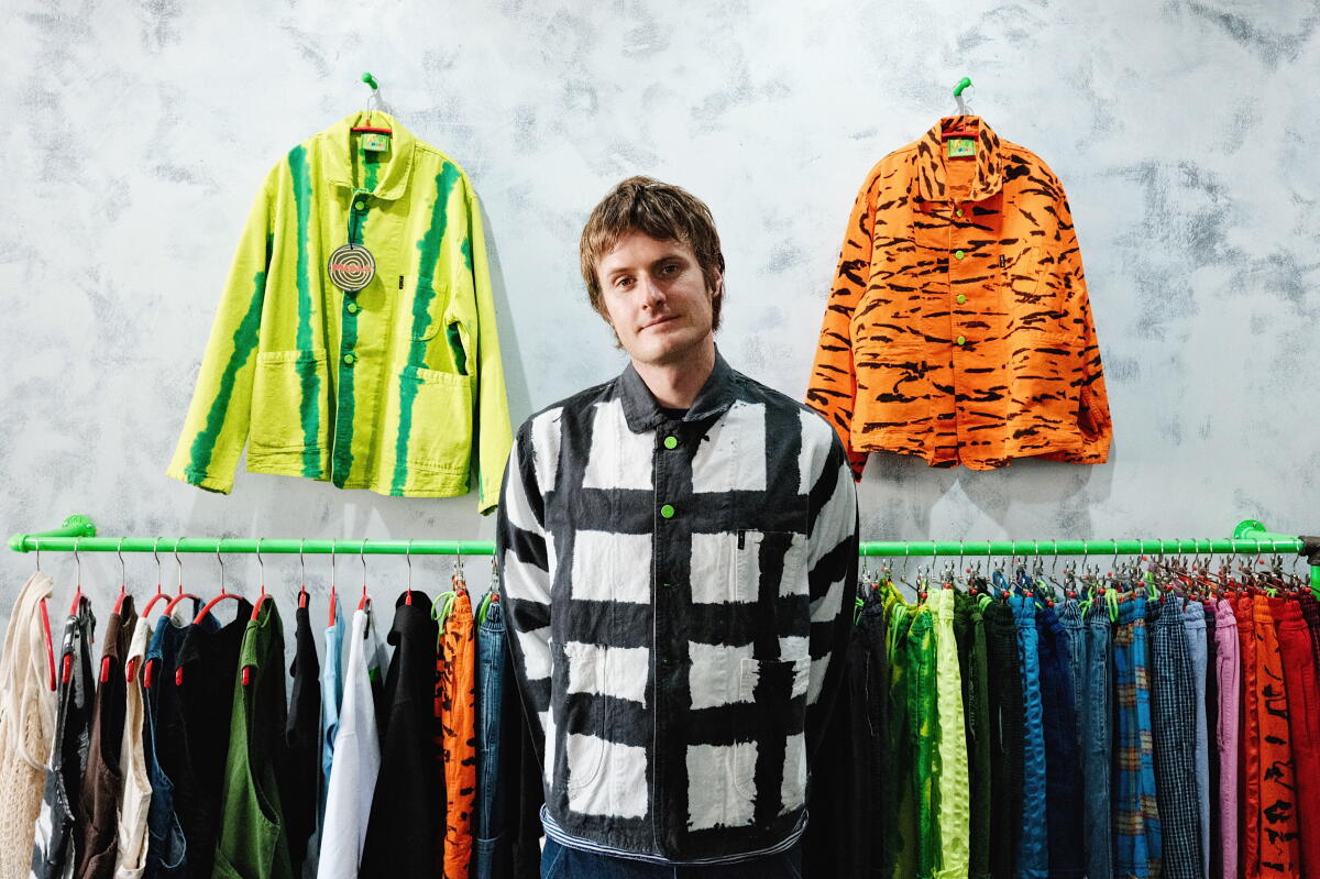 Meals Clothing co-founder Sam Salad stands amid his food-inspired, L.A.-made workwear in his Highland Park store 