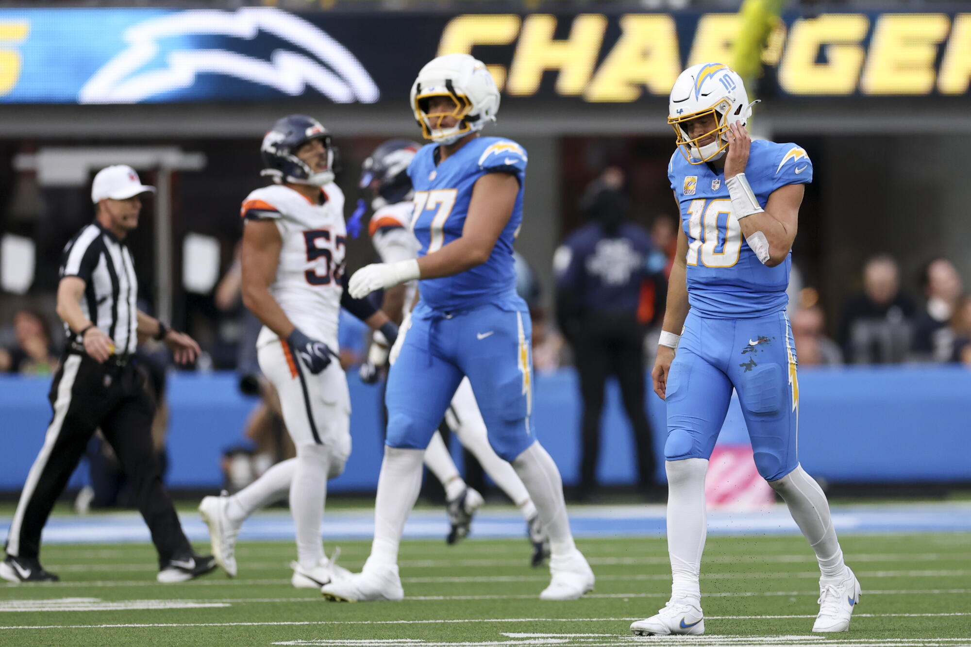 Chargers quarterback Justin Herbert walks off the field after fumbling the ball during the fourth quarter.