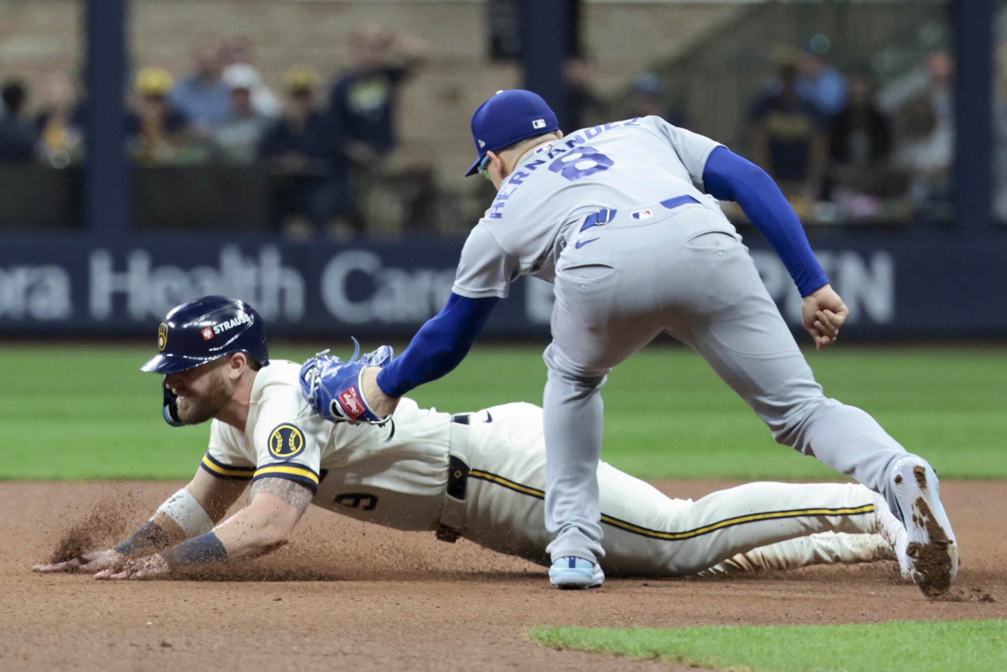 The Brewers' Jake Bauers is tagged out by Dodgers second baseman Kiké Hernández after being picked off by pitcher Alex Vesia.