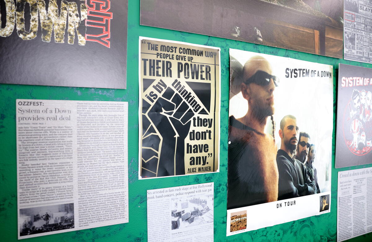 Posters and articles about System of a Down on display at the "Toxicity" exhibit