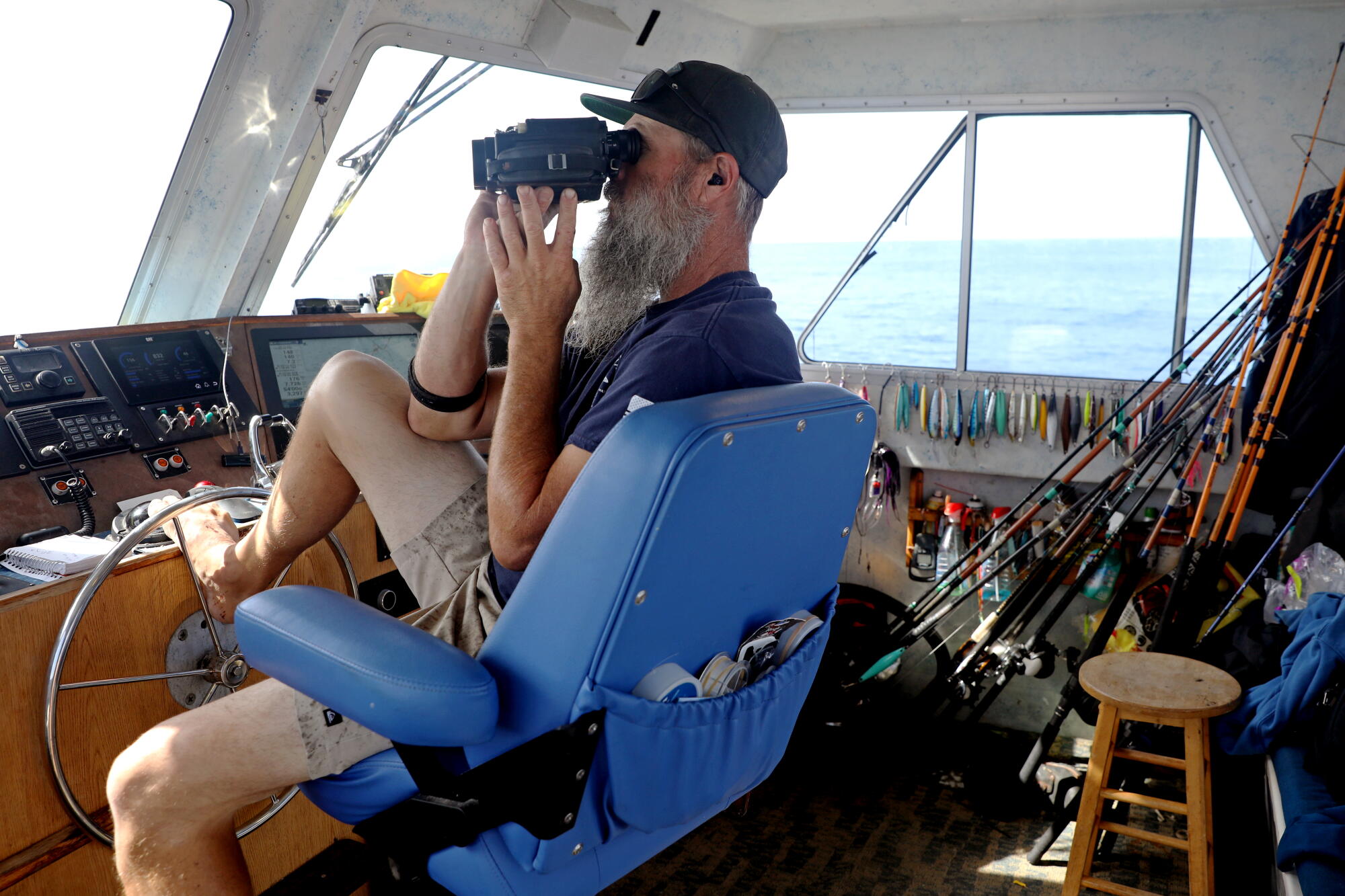Brandon Erdo, captain of the Dana Pride, scans the waters off the coast in search of fish.