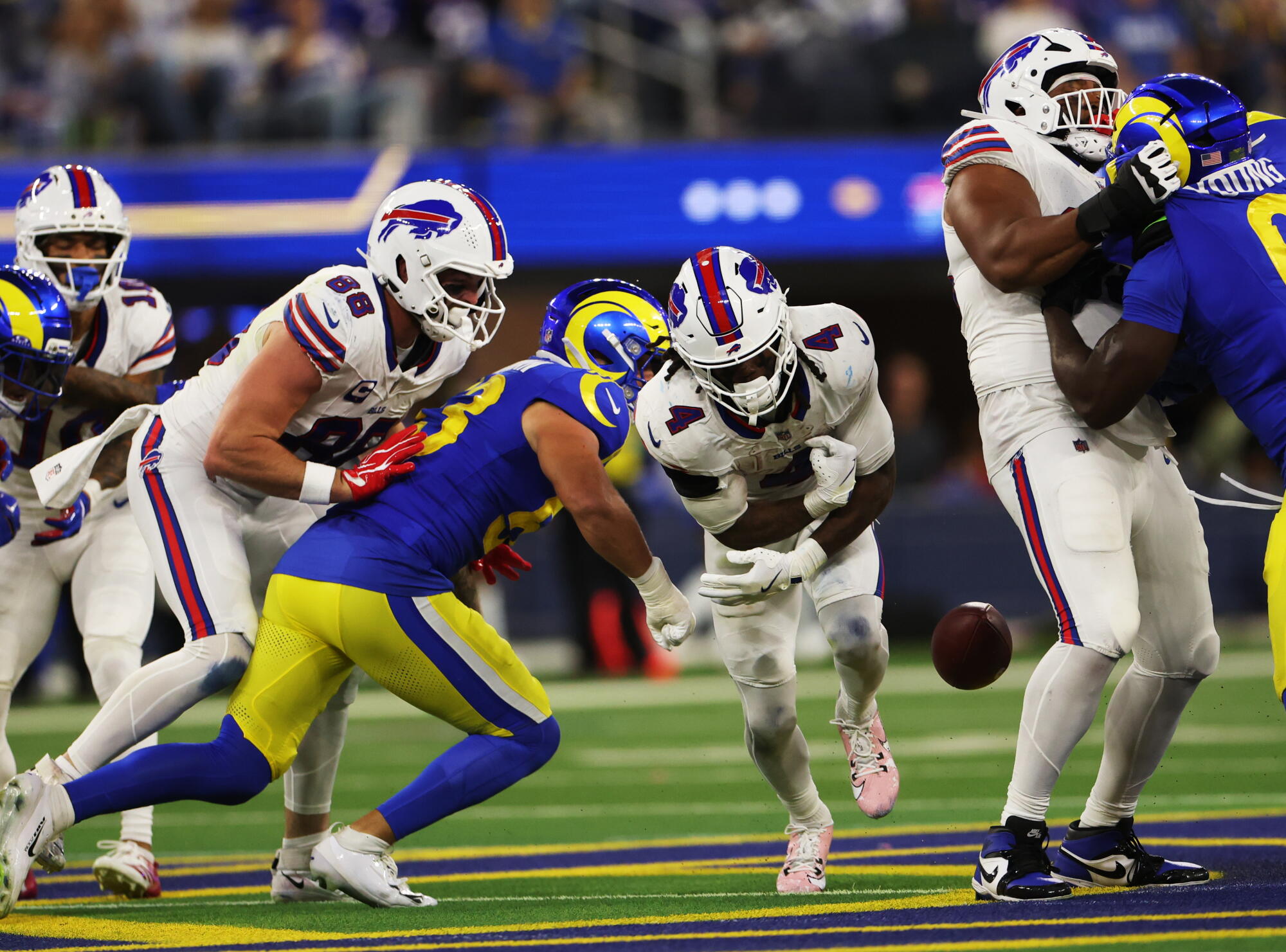 Rams linebacker Nate Landman punches the ball out of Bills running back James Cook III's arms during the third quarter.