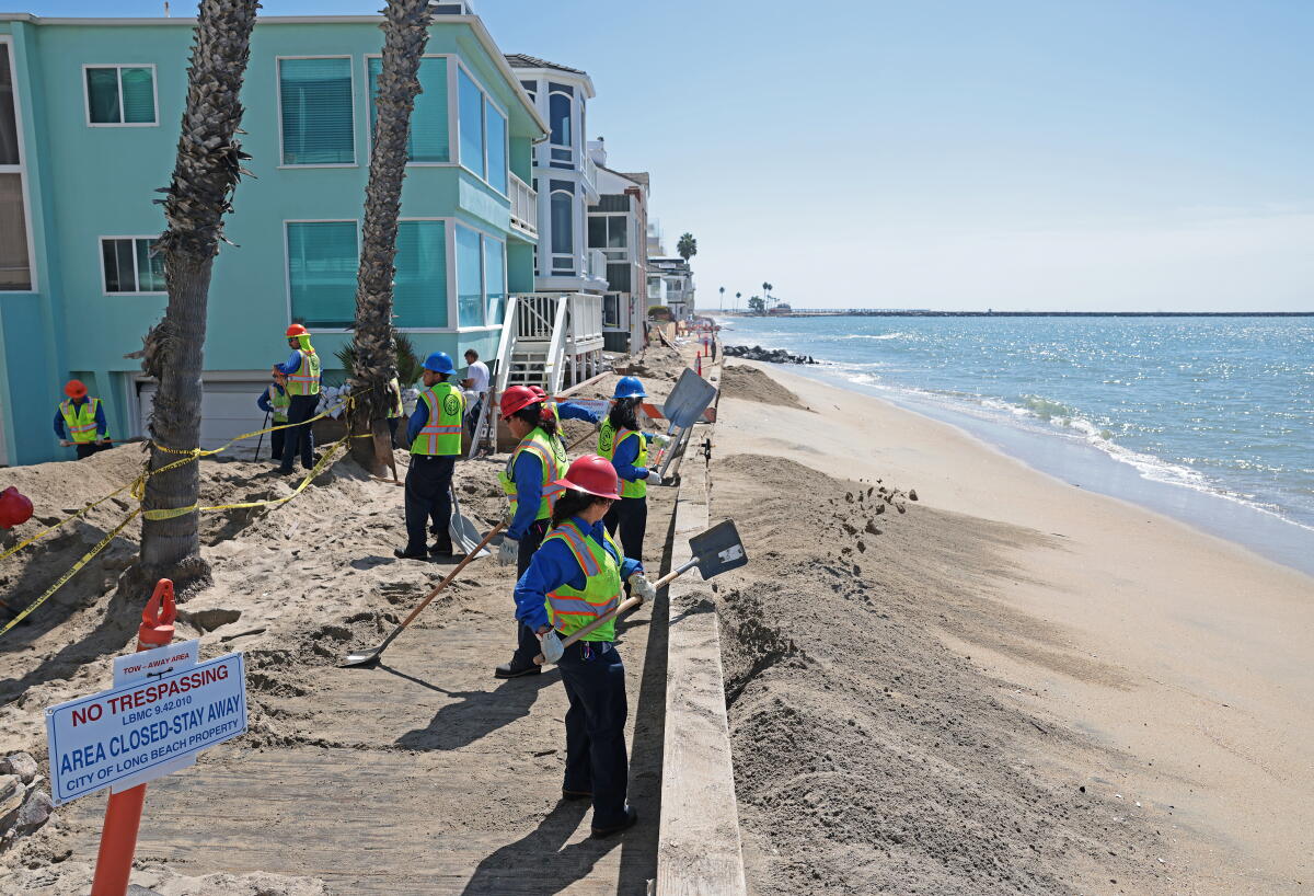 Crews shovel sand on the Long Beach Peninsula after the storm damaged parts of the boardwalk on Sept. 11. 