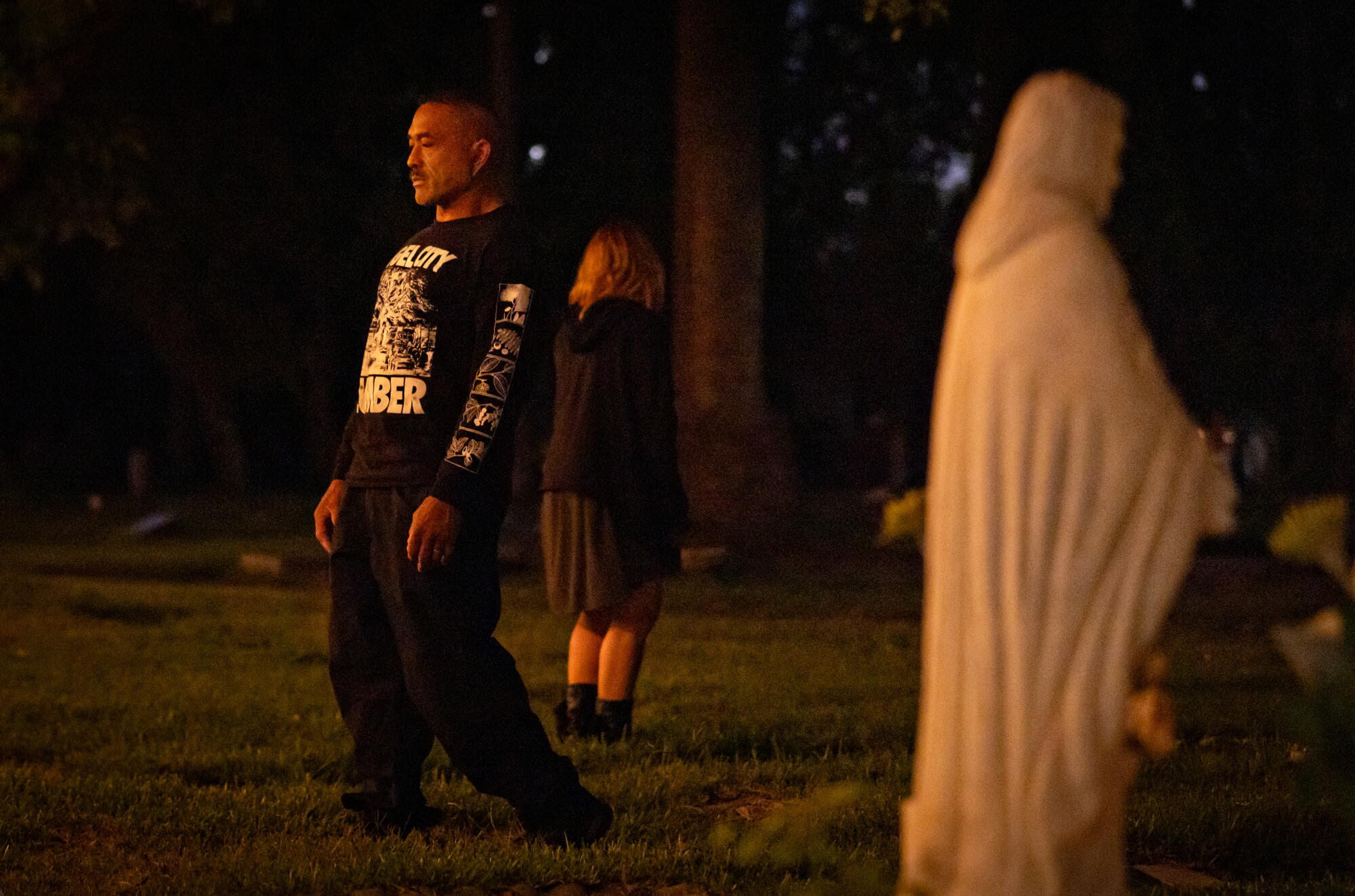 James Rokel practices mindfulness while walking alongside tombstones.